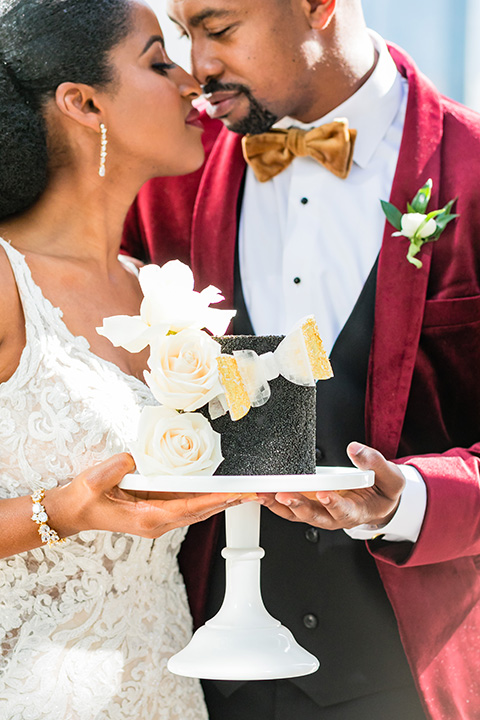  glitz and glam shoot at the Hotel Indigo – couple with cake