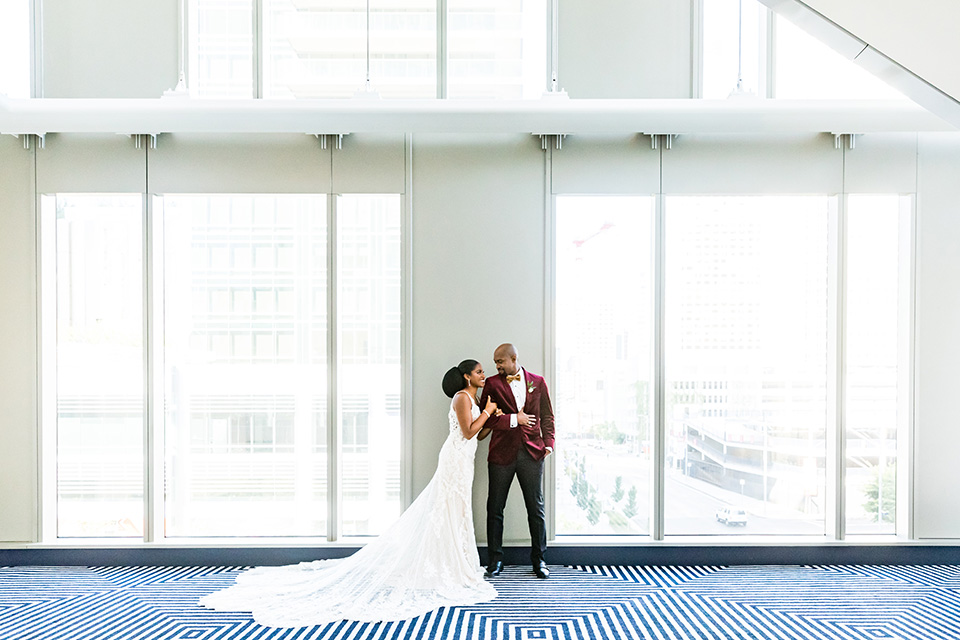  glitz and glam shoot at the Hotel Indigo – couple by windows 