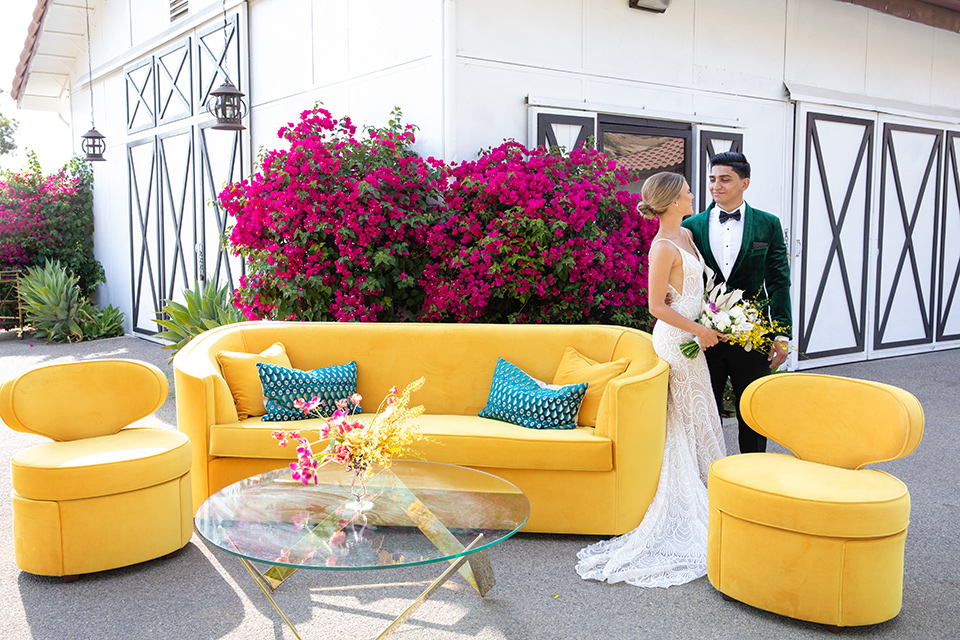 bright colorful wedding with the groom in a green velvet tuxedo – on the couch 