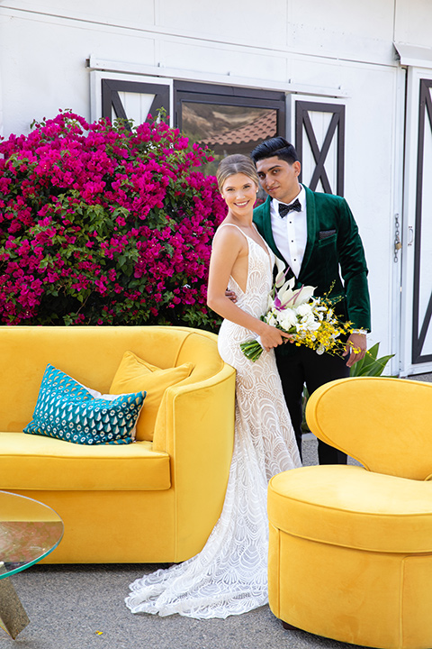  bright colorful wedding with the groom in a green velvet tuxedo - couch 