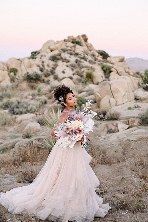  Iridescent dreams in the desert with the bride in a pink dress and the groom in a rose suit - bride