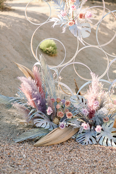  Iridescent dreams in the desert with the bride in a pink dress and the groom in a rose suit - florals