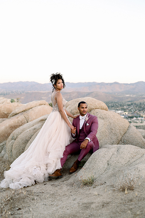  Iridescent dreams in the desert with the bride in a pink dress and the groom in a rose suit – couple dancing