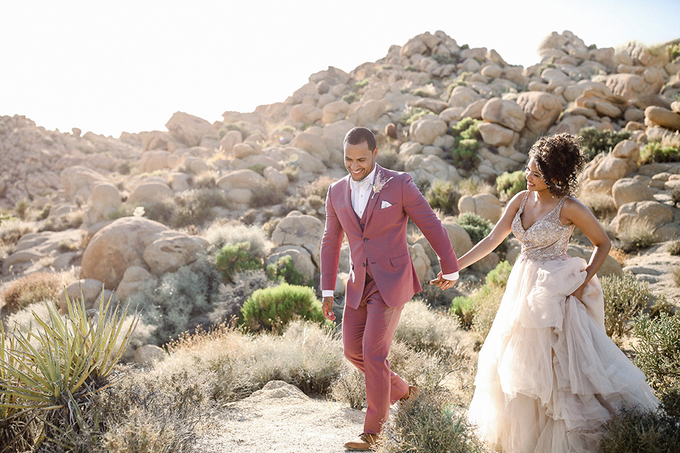  Iridescent dreams in the desert with the bride in a pink dress and the groom in a rose suit – couple in the desert