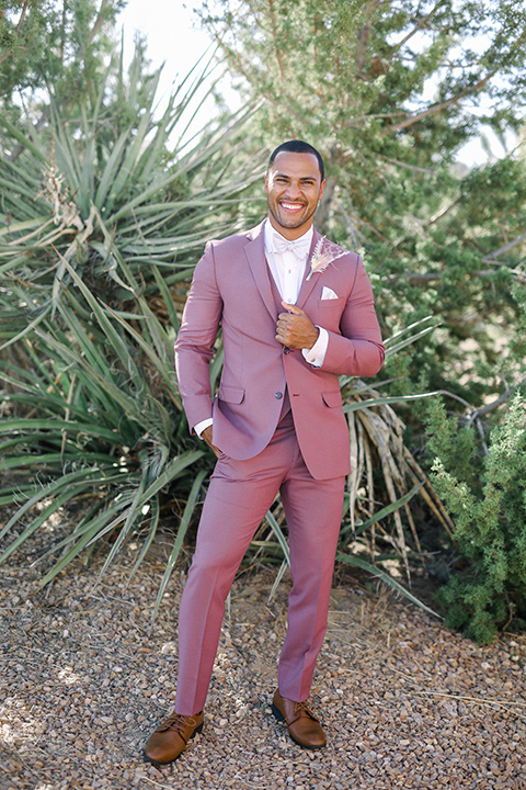  Iridescent dreams in the desert with the bride in a pink dress and the groom in a rose suit – couple close 