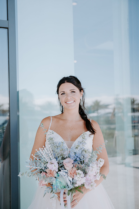  iridescent blue wedding design – bride in a tulle ballgown and the groom in a light blue suit 