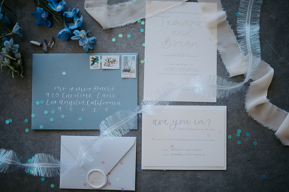  iridescent blue wedding design – bride in a tulle ballgown and the groom in a light blue suit 