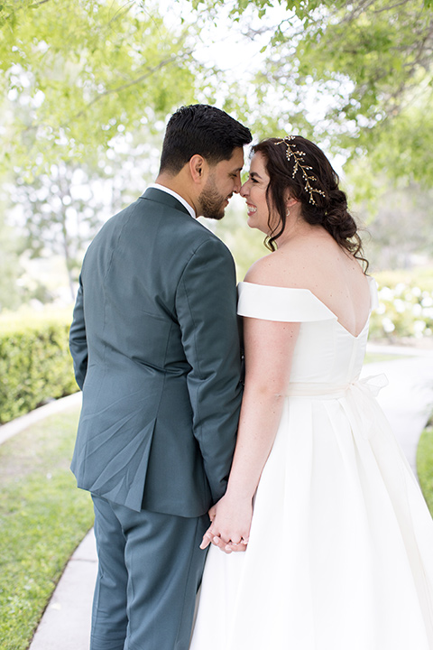  garden wedding with a green and pink color scheme – bride and groom kissing 