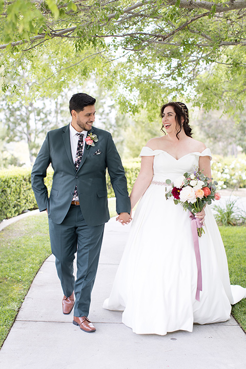  garden wedding with a green and pink color scheme – bride and groom walking 
