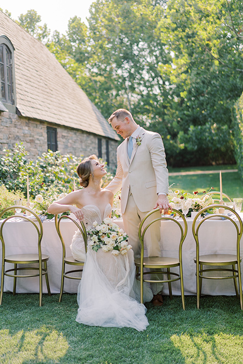  Kestrel Park wedding with the groom in a tan suit and the bride in an ivory wedding gown with a plunging neckline 