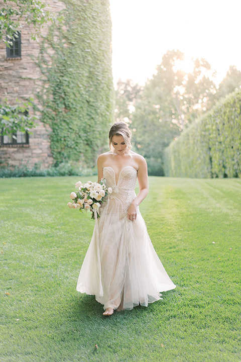  Kestrel Park wedding with the groom in a tan suit and the bride in an ivory wedding gown with a plunging neckline 