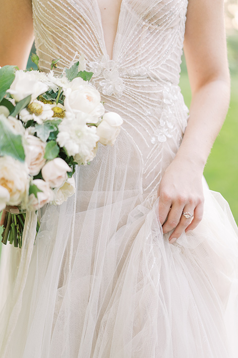  Kestrel Park wedding with the groom in a tan suit and the bride in an ivory wedding gown with a plunging neckline 