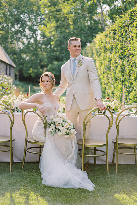  Kestrel Park wedding with the groom in a tan suit and the bride in an ivory wedding gown with a plunging neckline 