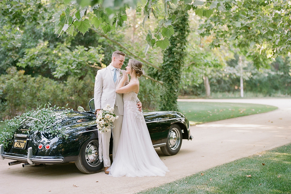  Kestrel Park wedding with the groom in a tan suit and the bride in an ivory wedding gown with a plunging neckline 