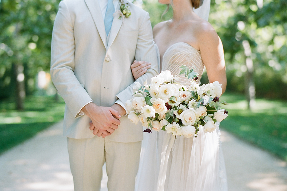  Kestrel Park wedding with the groom in a tan suit and the bride in an ivory wedding gown with a plunging neckline 