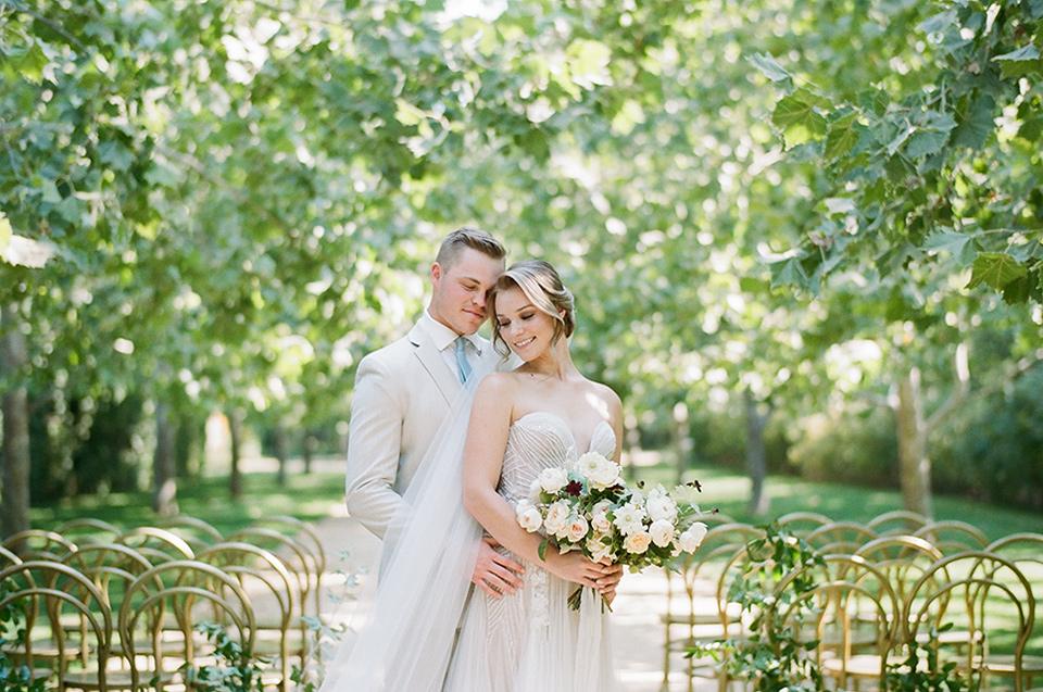  Kestrel Park wedding with the groom in a tan suit and the bride in an ivory wedding gown with a plunging neckline 