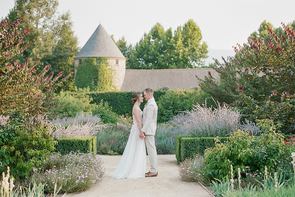  Kestrel Park wedding with the groom in a tan suit and the bride in an ivory wedding gown with a plunging neckline 