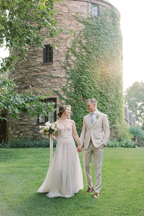  Kestrel Park wedding with the groom in a tan suit and the bride in an ivory wedding gown with a plunging neckline 