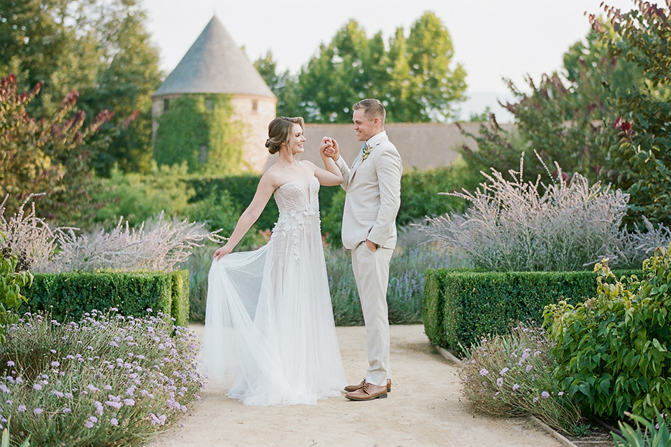  Kestrel Park wedding with the groom in a tan suit and the bride in an ivory wedding gown with a plunging neckline 