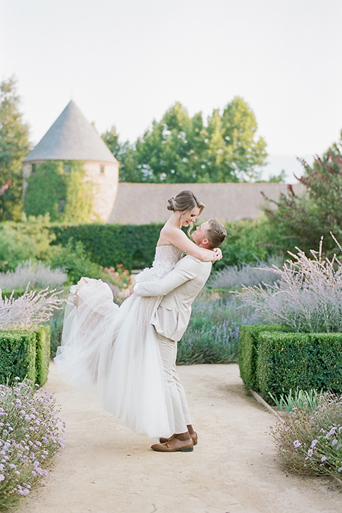  Kestrel Park wedding with the groom in a tan suit and the bride in an ivory wedding gown with a plunging neckline 