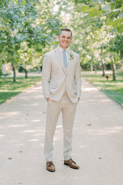  Kestrel Park wedding with the groom in a tan suit and the bride in an ivory wedding gown with a plunging neckline 