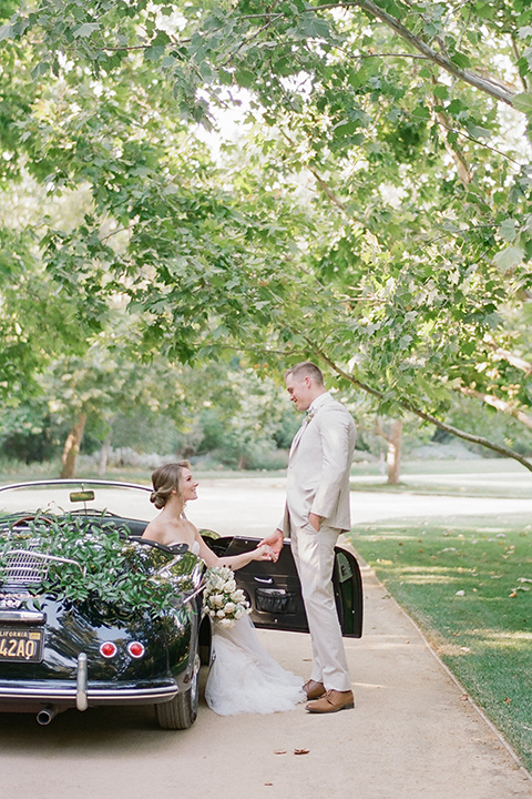  Kestrel Park wedding with the groom in a tan suit and the bride in an ivory wedding gown with a plunging neckline 