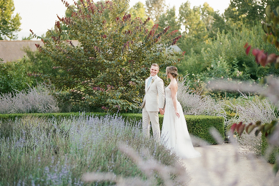  Kestrel Park wedding with the groom in a tan suit and the bride in an ivory wedding gown with a plunging neckline 