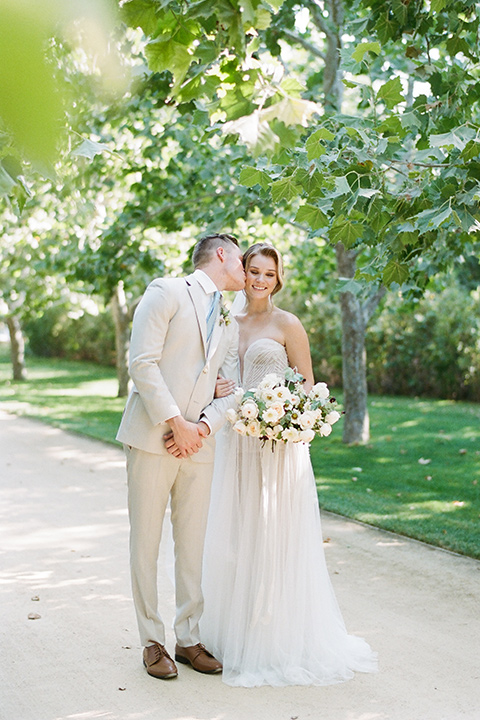  Kestrel Park wedding with the groom in a tan suit and the bride in an ivory wedding gown with a plunging neckline 