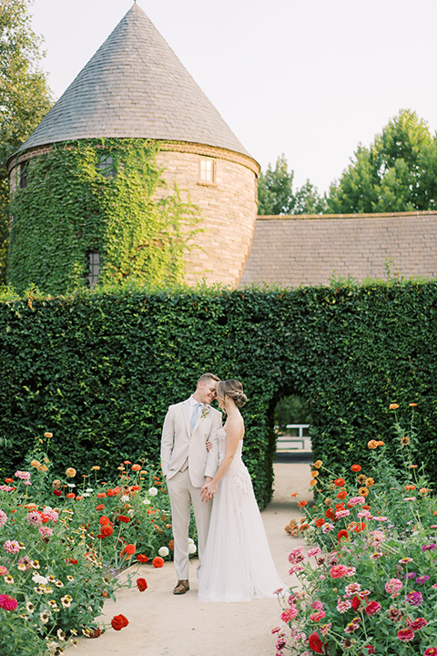  Kestrel Park wedding with the groom in a tan suit and the bride in an ivory wedding gown with a plunging neckline 