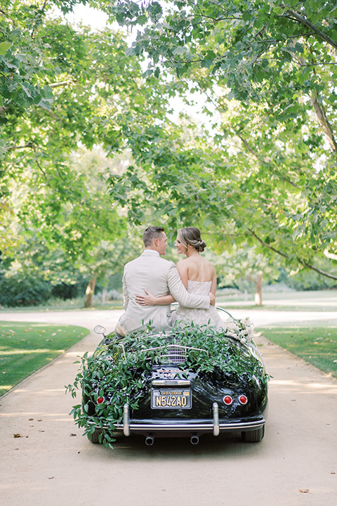  Kestrel Park wedding with the groom in a tan suit and the bride in an ivory wedding gown with a plunging neckline 