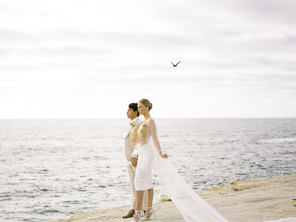  la jolla wedding on the beach with the groom in a tan suit – couple sitting