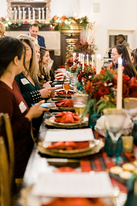  romantic winter inspired wedding theme with luxe textures and details, one groom wore a burgundy velvet shawl tuxedo and the other groom in a black paisley tuxedo – green gold and red table décor 