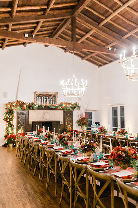  romantic winter inspired wedding theme with luxe textures and details, one groom wore a burgundy velvet shawl tuxedo and the other groom in a black paisley tuxedo – green gold and red table décor