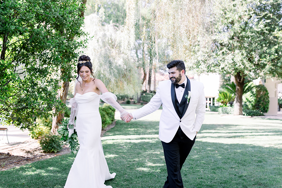  black and white wedding design with touches of greenery – couple walking 