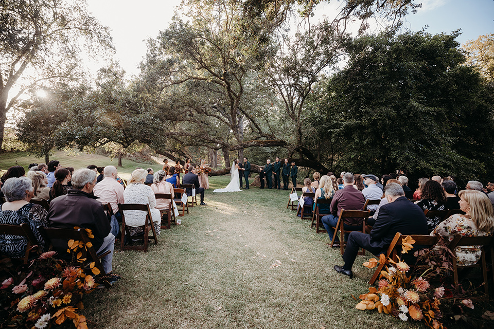  boho autumn wedding with the groom and groomsmen in a green suit –ceremony