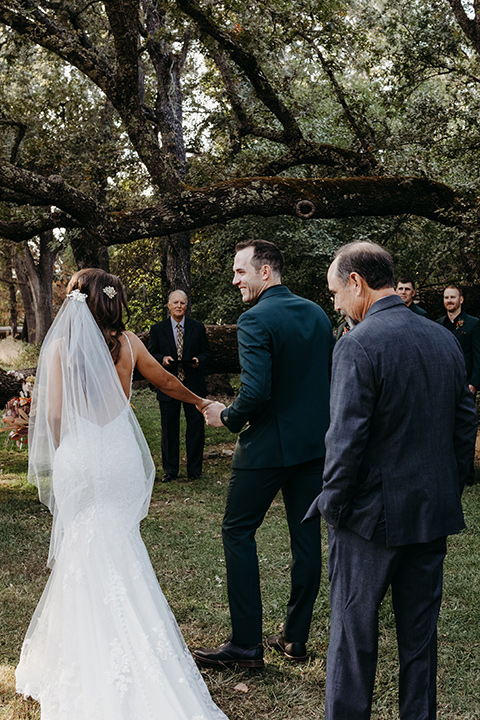  boho autumn wedding with the groom and groomsmen in a green suit – bride 