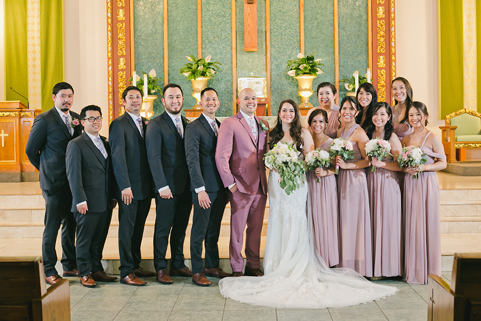  garden wedding at rancho los Cerritos with the groom in a rose pink suit and the groomsmen in navy suits 