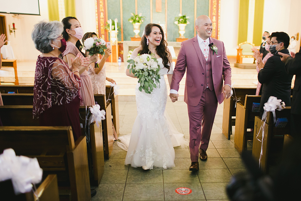  garden wedding at rancho los Cerritos with the groom in a rose pink suit and the groomsmen in navy suits 