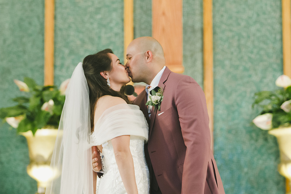  garden wedding at rancho los Cerritos with the groom in a rose pink suit and the groomsmen in navy suits 