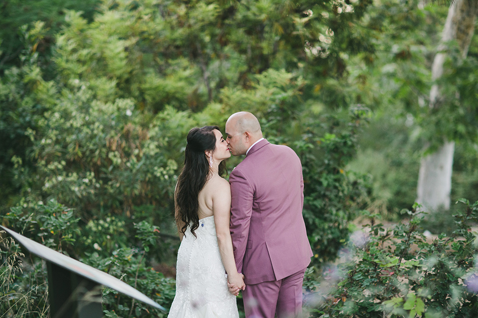  garden wedding at rancho los Cerritos with the groom in a rose pink suit and the groomsmen in navy suits 