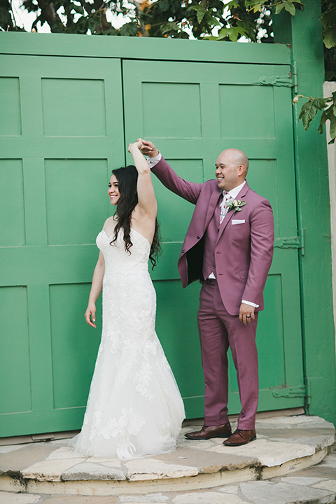  garden wedding at rancho los Cerritos with the groom in a rose pink suit and the groomsmen in navy suits 