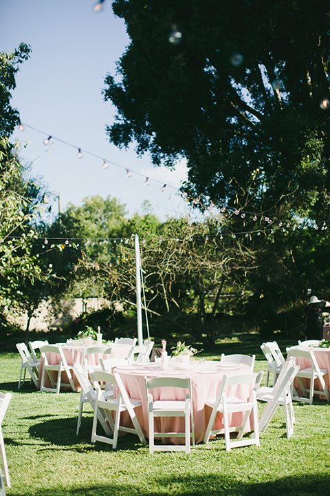  garden wedding at rancho los Cerritos with the groom in a rose pink suit and the groomsmen in navy suits 