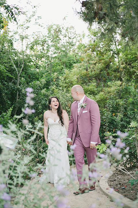  garden wedding at rancho los Cerritos with the groom in a rose pink suit and the groomsmen in navy suits 