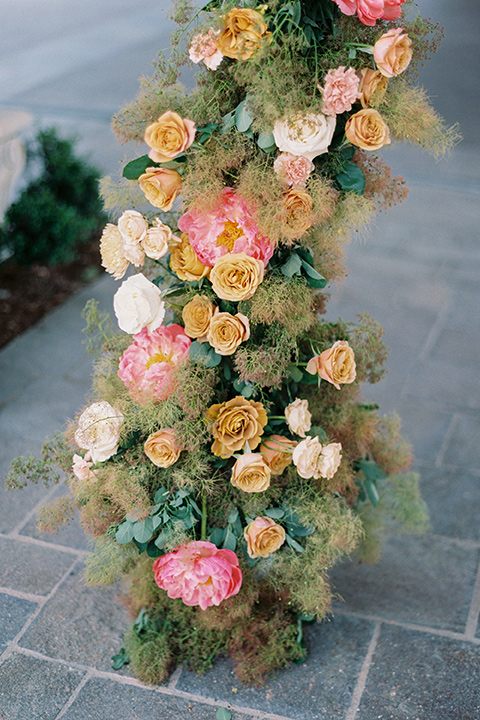  old world garden wedding design with yellow and pink flowers and the groom in a navy shawl tuxedo – ceremony arch 