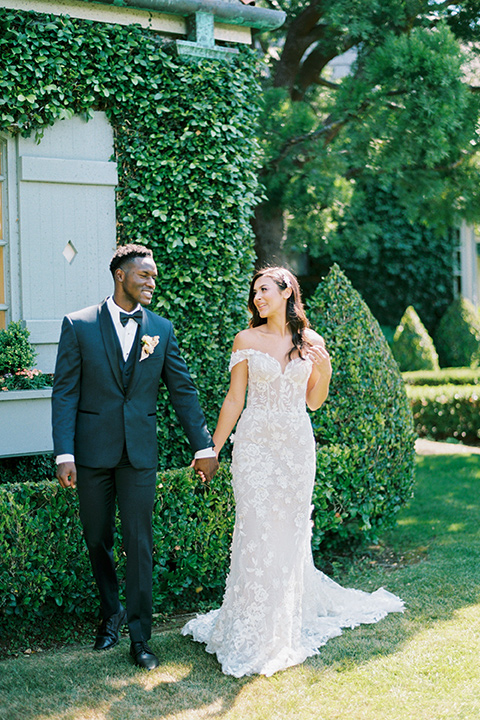  old world garden wedding design with yellow and pink flowers and the groom in a navy shawl tuxedo – ceremony 