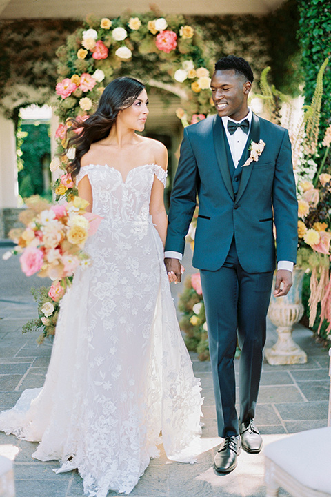  old world garden wedding design with yellow and pink flowers and the groom in a navy shawl tuxedo – ceremony arch 