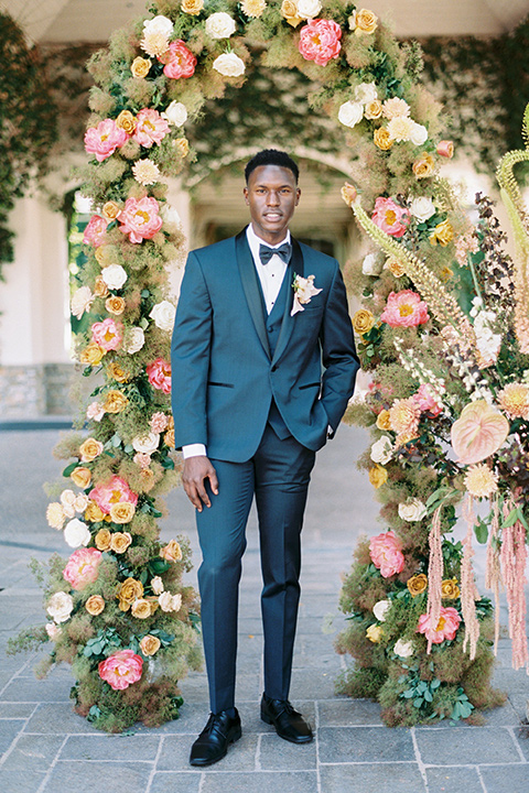  old world garden wedding design with yellow and pink flowers and the groom in a navy shawl tuxedo – ceremony 