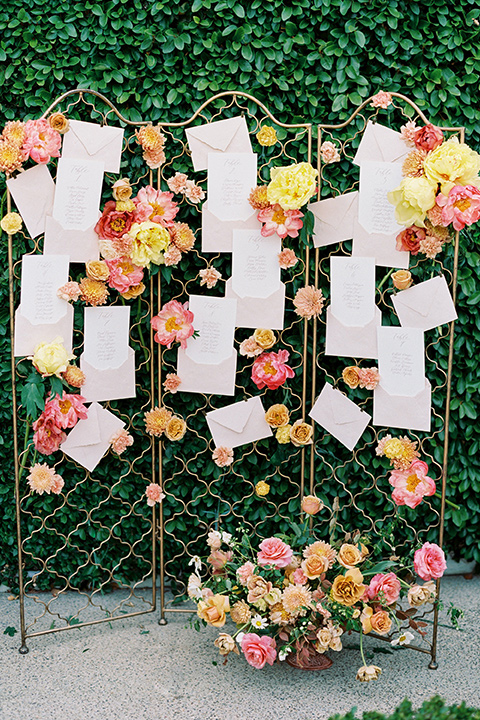  old world garden wedding design with yellow and pink flowers and the groom in a navy shawl tuxedo – ceremony 