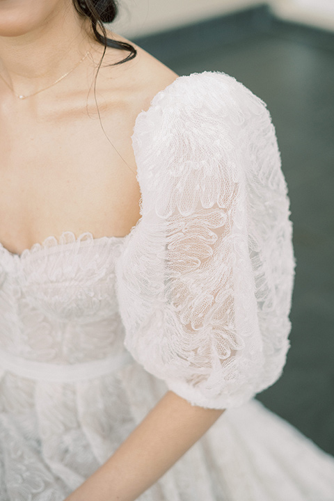  a neutral romantic wedding with touches of peach colors and the groom in a tan suit- bride 