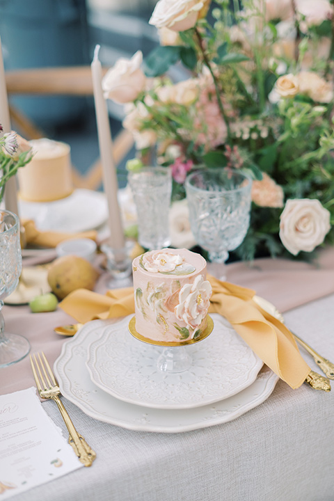  a neutral romantic wedding with touches of peach colors and the groom in a tan suit- cake 